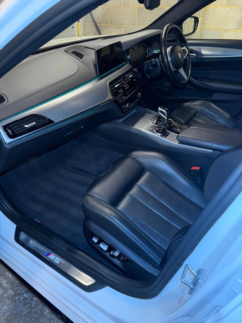Black leather interior of a BMW M5 cleaned and conditioned by ASR Detailing