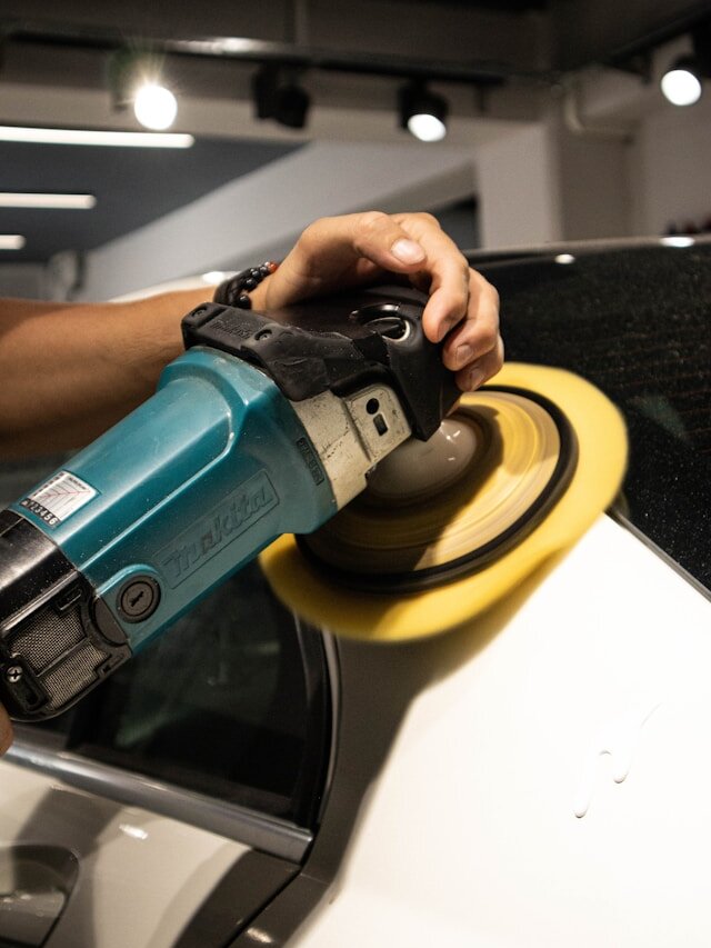 Machine polisher being used to correct paintwork